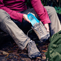 Man outside placing CURREX HIKEPRO insoles into shoe before going on the hiking trail #1-wahle-dein-profil_high