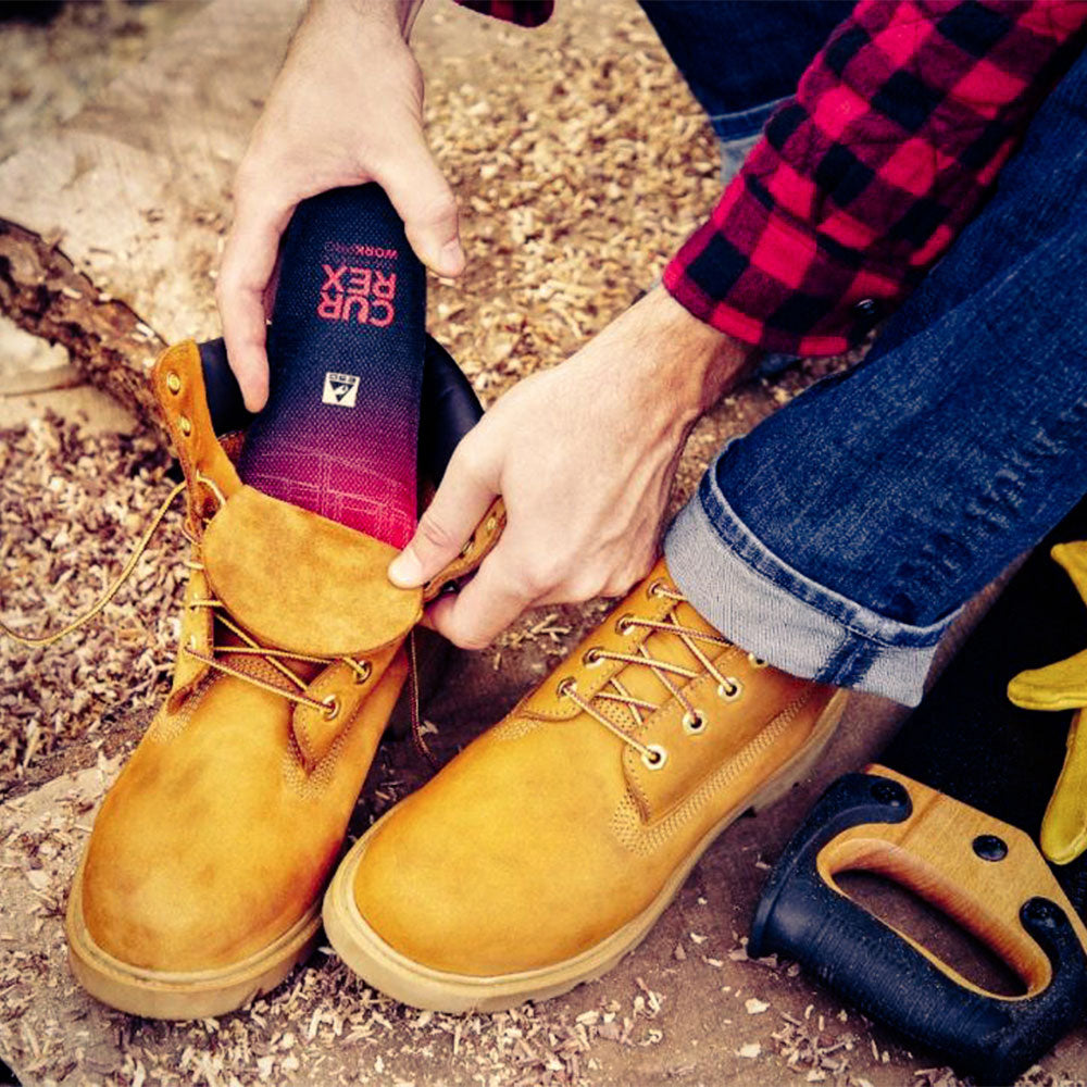 Man placing CURREX WORK low-profile red insole into work boot #1-wahle-dein-profil_low